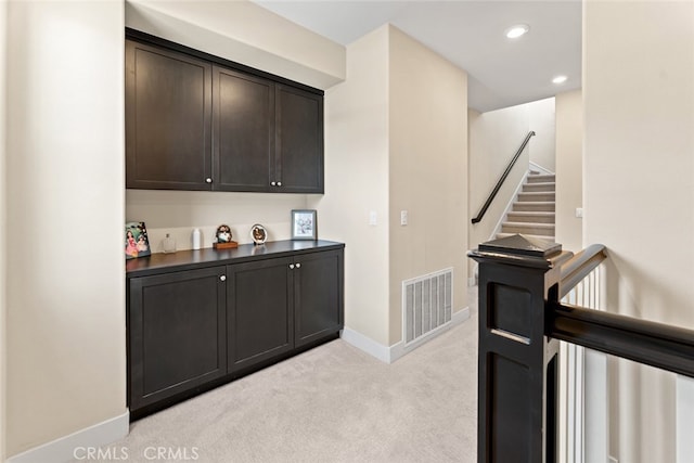 bar with light colored carpet, stairs, recessed lighting, baseboards, and visible vents