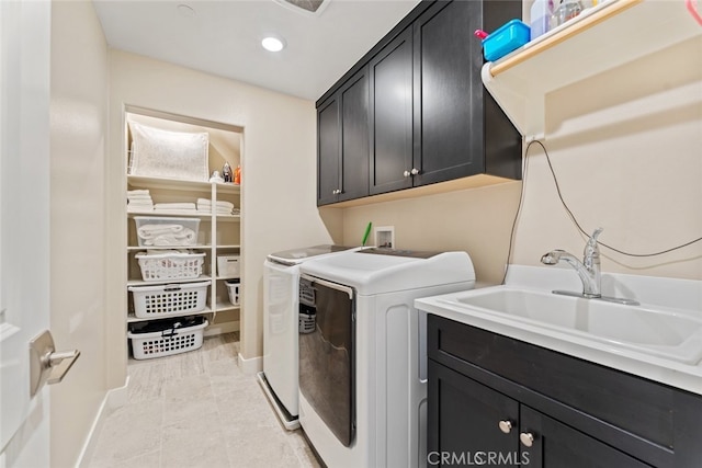 laundry area with washer and dryer, baseboards, recessed lighting, a sink, and cabinet space