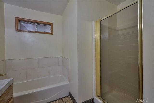 full bathroom featuring a garden tub, a stall shower, and vanity