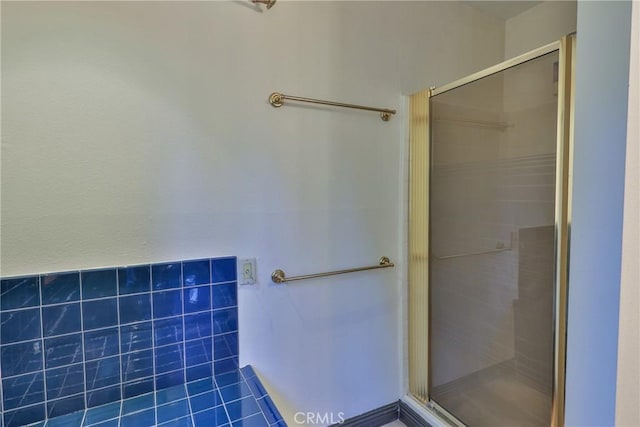 full bathroom with tile patterned flooring and a stall shower