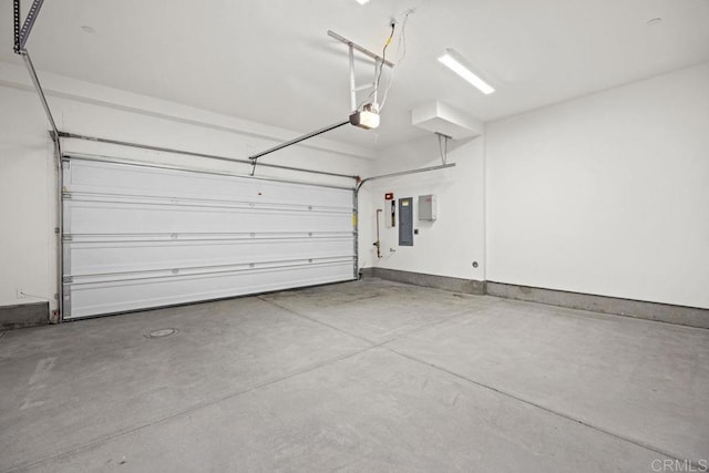 garage with a garage door opener and electric panel
