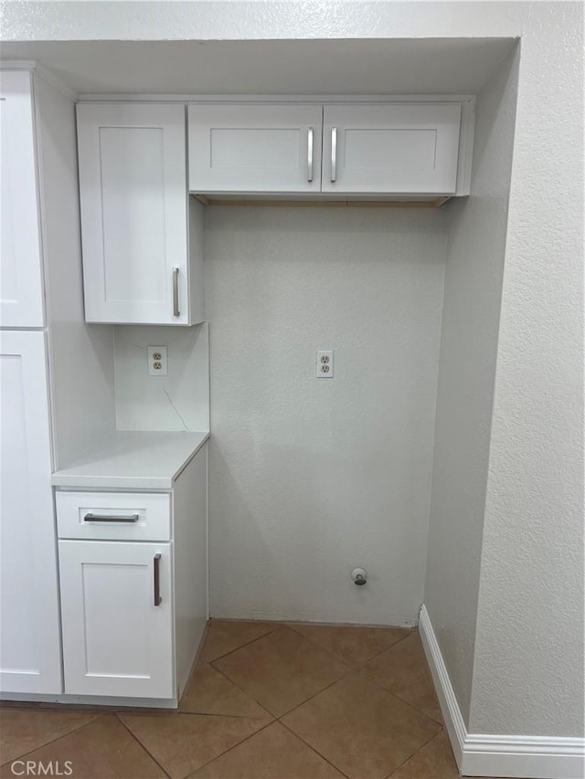 washroom with tile patterned floors and baseboards