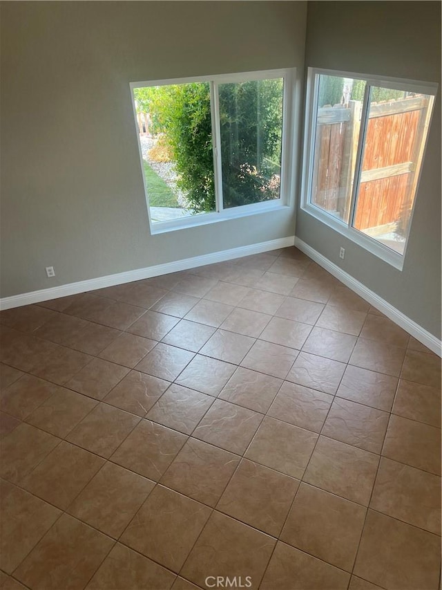 tiled empty room with baseboards