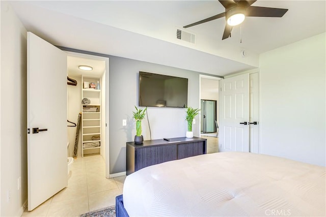 1100 E Amado Rd Unit 11A1, Palm Springs, CA 92262 - bedroom with a walk in closet, light tile patterned flooring, a closet, baseboards, and a ceiling fan
