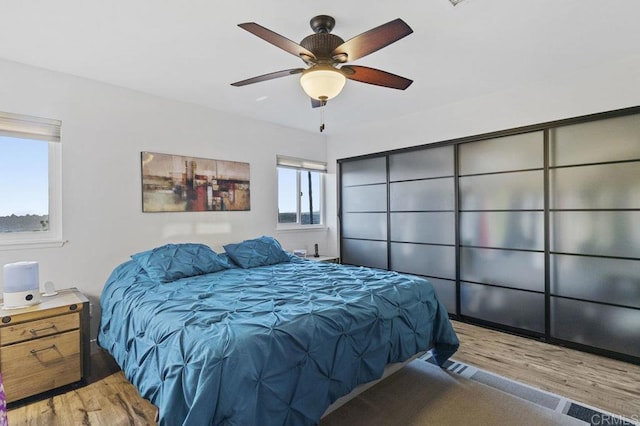 bedroom with a ceiling fan and wood finished floors