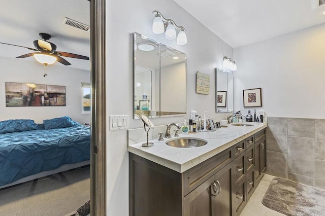 full bathroom featuring ceiling fan, visible vents, a sink, and tile patterned floors