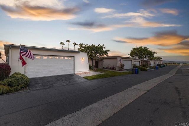 view of front of property with driveway and stucco siding