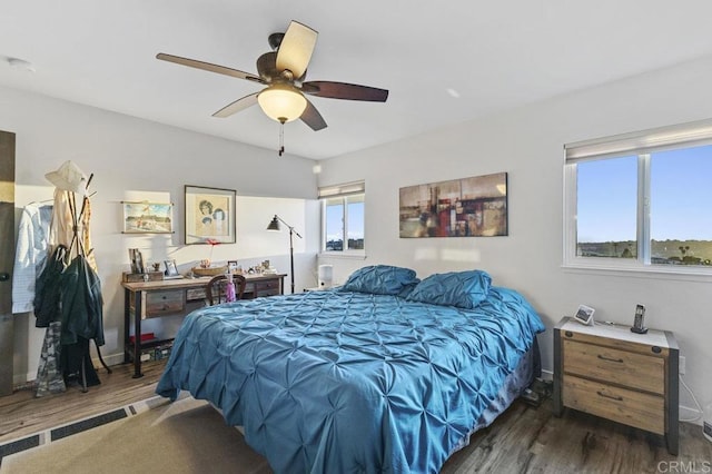 bedroom with baseboards, a ceiling fan, and wood finished floors