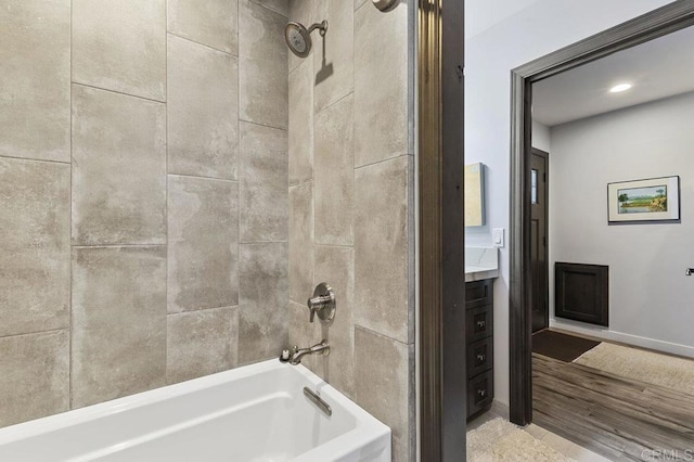 bathroom with shower / tub combination, recessed lighting, baseboards, and wood finished floors