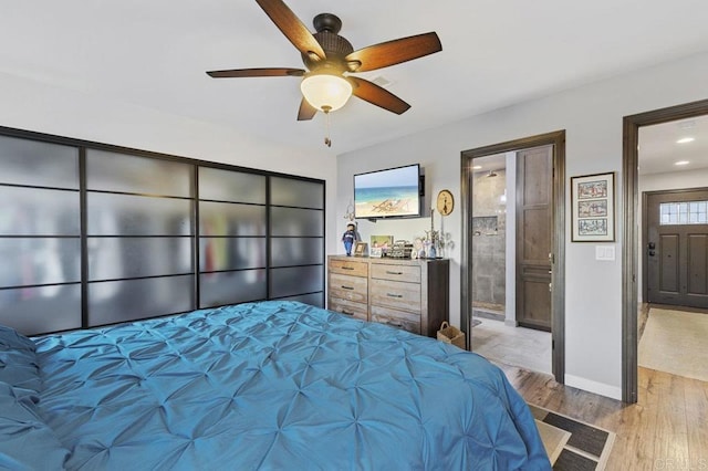bedroom with connected bathroom, baseboards, ceiling fan, and light wood-style floors