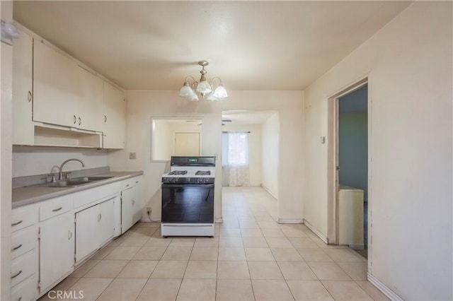 10180 Eddystone St, Riverside, CA 92503 - kitchen featuring a sink, light countertops, a chandelier, range with gas stovetop, and white cabinetry