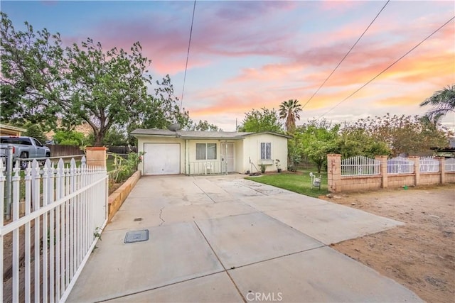 10180 Eddystone St, Riverside, CA 92503 - view of front of home featuring fence private yard, a garage, and concrete driveway
