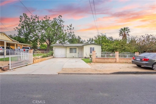 10180 Eddystone St, Riverside, CA 92503 - view of front facade with a garage, a fenced front yard, and concrete driveway