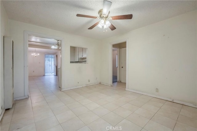 10180 Eddystone St, Riverside, CA 92503 - spare room with baseboards, ceiling fan with notable chandelier, a textured ceiling, and light tile patterned flooring
