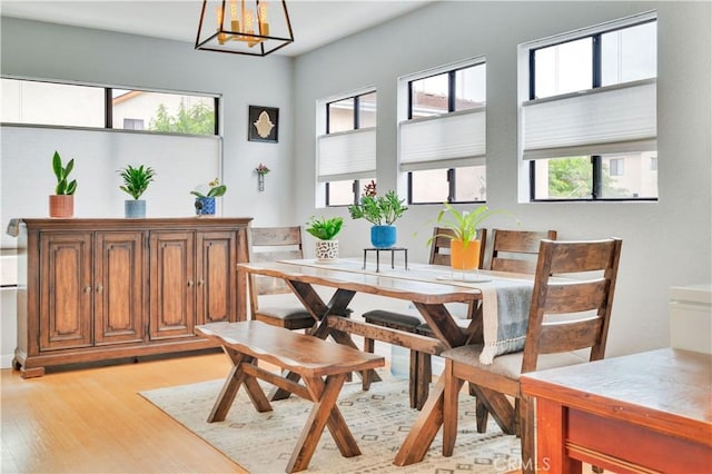 dining room featuring an inviting chandelier and light wood-style floors