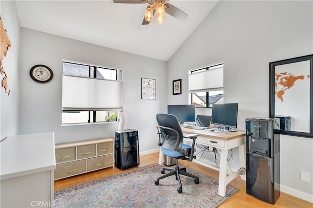 office space with a ceiling fan, baseboards, plenty of natural light, and light wood finished floors
