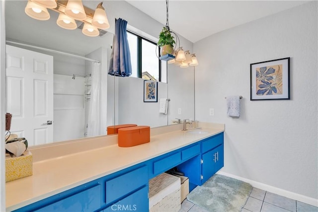 full bath with a notable chandelier, tile patterned flooring, vanity, baseboards, and curtained shower
