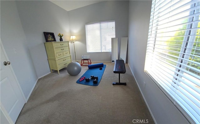 workout area featuring carpet and baseboards