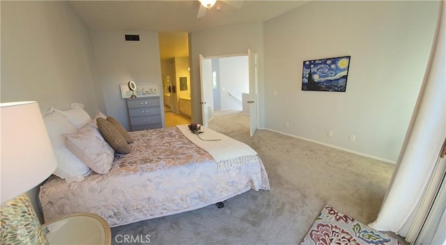 bedroom featuring baseboards, carpet flooring, ensuite bath, and visible vents