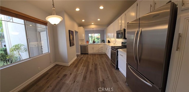 kitchen with stainless steel appliances, white cabinets, dark wood-style floors, light countertops, and recessed lighting