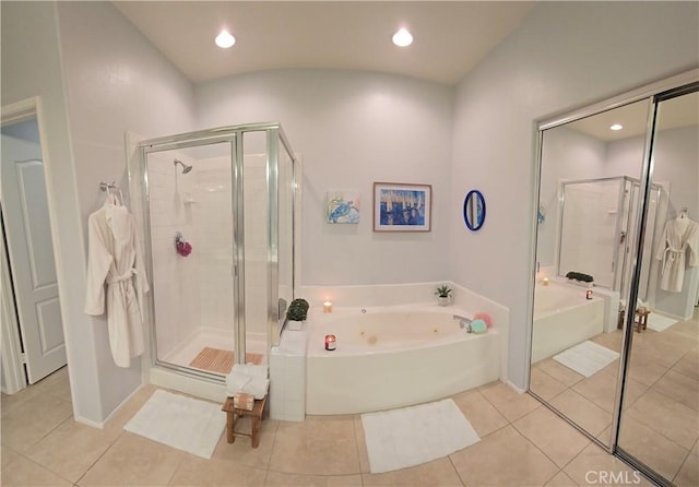 bathroom with tile patterned floors, a bath, a stall shower, and recessed lighting
