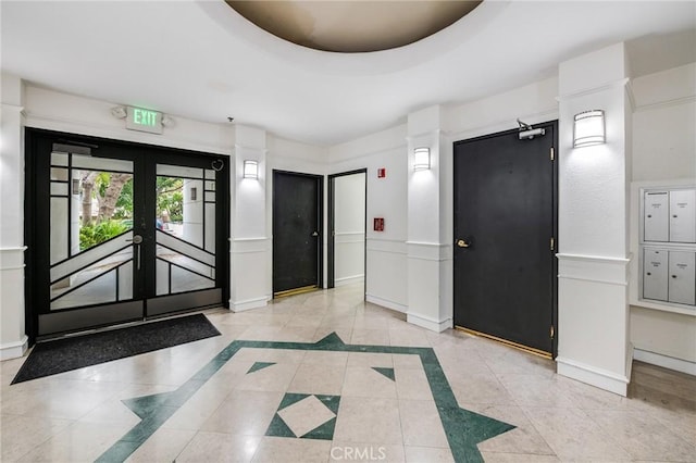 foyer featuring baseboards, french doors, and light tile patterned floors