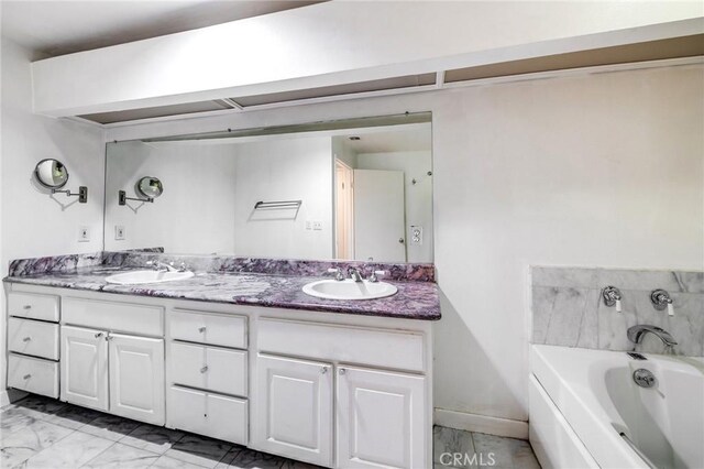 1401 S Bentley Ave Unit 203, Los Angeles, CA 90025 - bathroom with double vanity, a bath, and marble finish floors