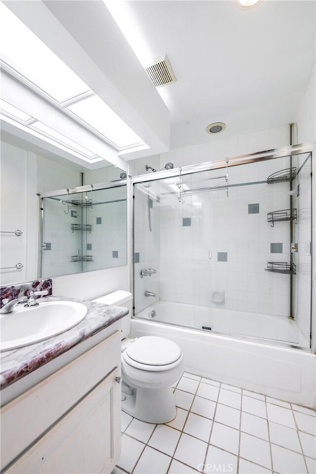 1401 S Bentley Ave Unit 203, Los Angeles, CA 90025 - bathroom featuring tile patterned floors, vanity, shower / bath combination with glass door, and toilet