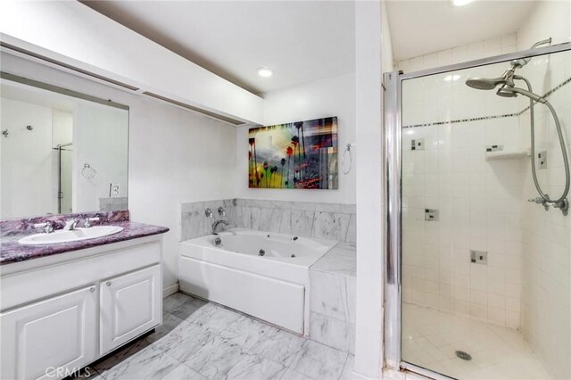 1401 S Bentley Ave Unit 203, Los Angeles, CA 90025 - full bath with a tub with jets, a stall shower, vanity, marble finish floors, and recessed lighting
