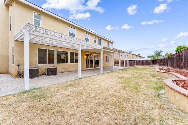 back of property with central AC, a pergola, a fenced backyard, stucco siding, and a patio area