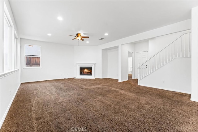 unfurnished living room with recessed lighting, ceiling fan, carpet flooring, and stairs