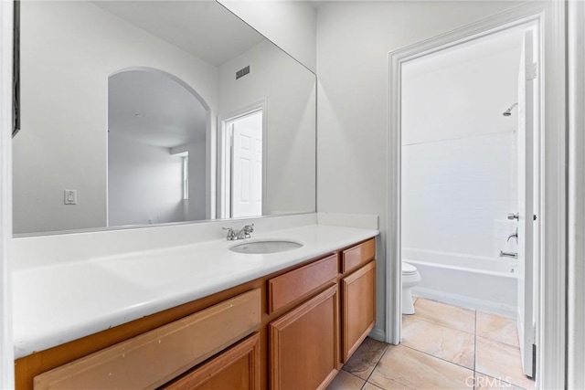 bathroom with vanity, toilet, bathing tub / shower combination, and visible vents