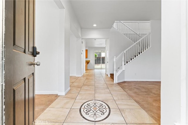 foyer with recessed lighting, baseboards, and stairway