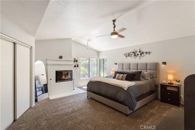41787 Humber Dr, Temecula, CA 92591 - bedroom featuring carpet floors, lofted ceiling, a tile fireplace, a ceiling fan, and a closet