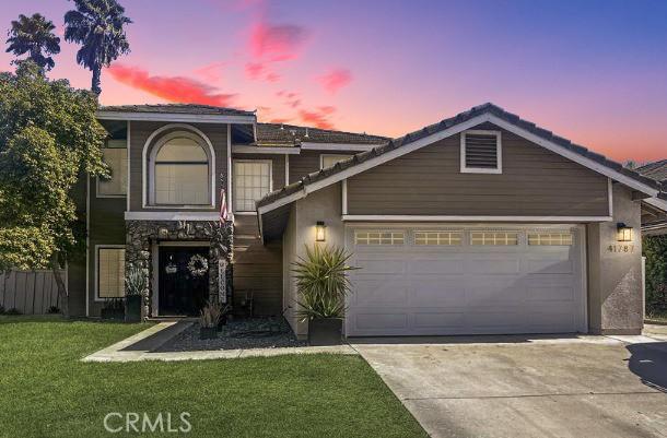 41787 Humber Dr, Temecula, CA 92591 - view of front of home featuring driveway, a garage, a front lawn, and stucco siding