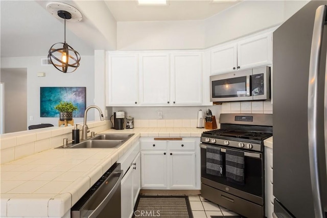 41787 Humber Dr, Temecula, CA 92591 - kitchen featuring appliances with stainless steel finishes, a sink, white cabinetry, a peninsula, and light tile patterned floors