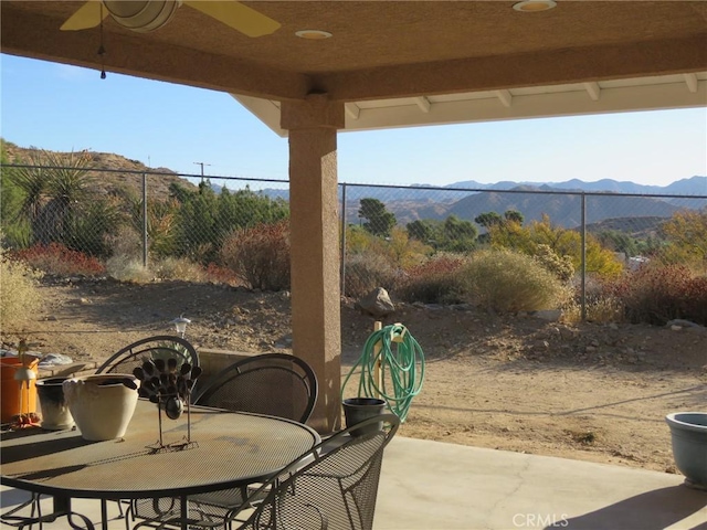 48628 Adeline Way, Morongo Valley, CA 92256 - view of patio featuring a mountain view, outdoor dining space, fence, and ceiling fan