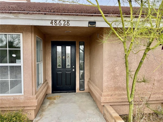 48628 Adeline Way, Morongo Valley, CA 92256 - doorway to property featuring stucco siding