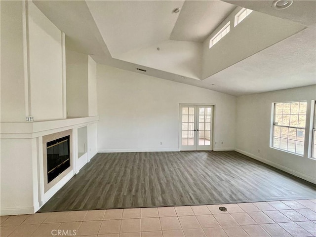 48628 Adeline Way, Morongo Valley, CA 92256 - unfurnished living room with a tile fireplace, baseboards, plenty of natural light, and wood finished floors