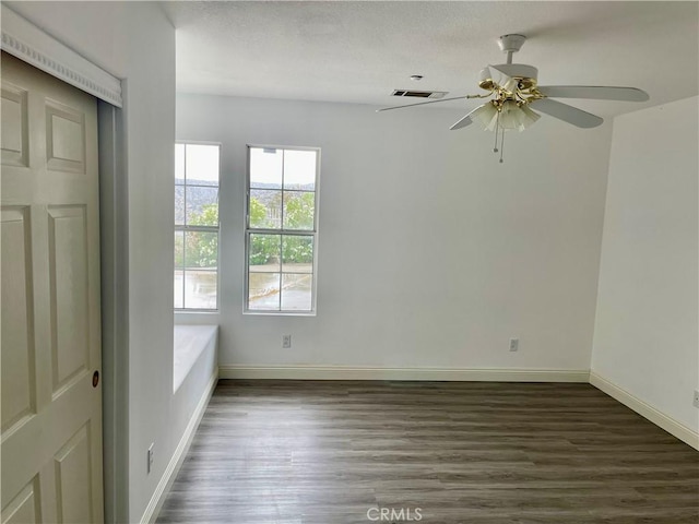 48628 Adeline Way, Morongo Valley, CA 92256 - spare room with ceiling fan, baseboards, dark wood-style floors, and visible vents