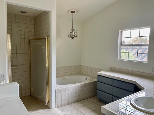 48628 Adeline Way, Morongo Valley, CA 92256 - bathroom featuring tile patterned floors, a bath, a chandelier, and a sink
