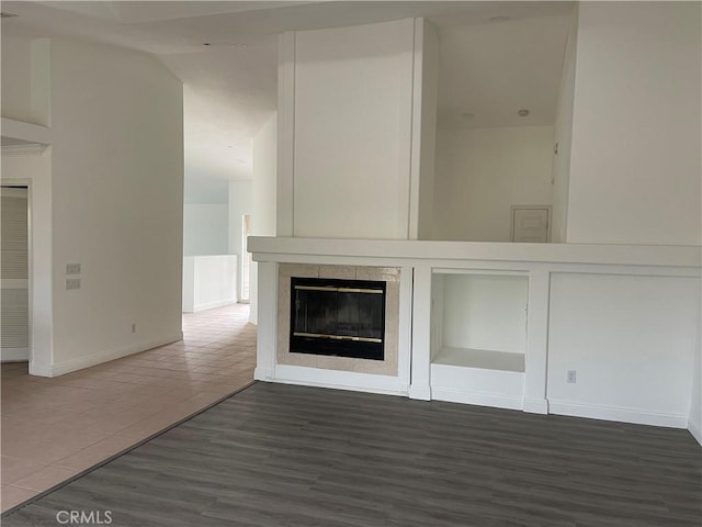 48628 Adeline Way, Morongo Valley, CA 92256 - interior details with wood finished floors, a tiled fireplace, and baseboards