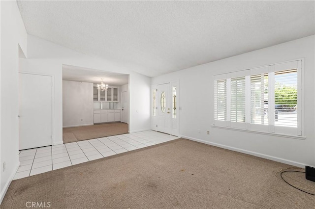 1620 S Cypress Ave, Ontario, CA 91762 - carpeted foyer entrance featuring a chandelier, healthy amount of natural light, a textured ceiling, tile patterned floors, and vaulted ceiling