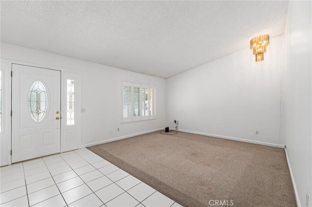 1620 S Cypress Ave, Ontario, CA 91762 - entrance foyer featuring light colored carpet, a textured ceiling, and light tile patterned floors