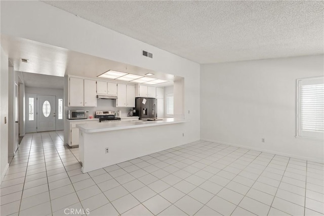 1620 S Cypress Ave, Ontario, CA 91762 - kitchen with appliances with stainless steel finishes, light countertops, a textured ceiling, a peninsula, and white cabinetry