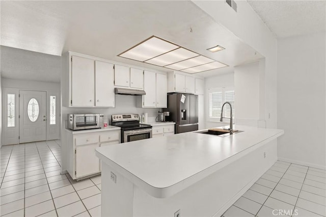 1620 S Cypress Ave, Ontario, CA 91762 - kitchen with stainless steel appliances, light tile patterned flooring, plenty of natural light, under cabinet range hood, and a textured ceiling
