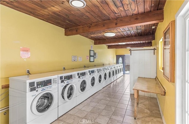 community laundry room with independent washer and dryer, baseboards, wooden ceiling, and light tile patterned floors