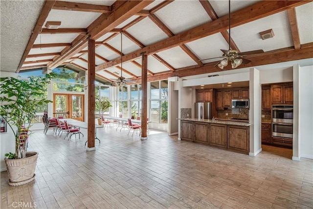 interior space with french doors, a ceiling fan, outdoor dining space, and area for grilling