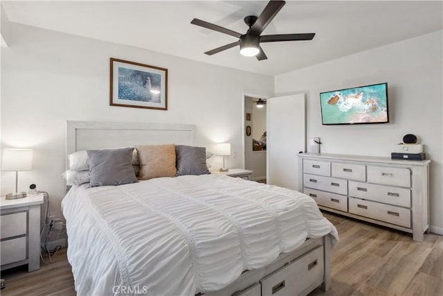 bedroom with a ceiling fan and light wood-style floors