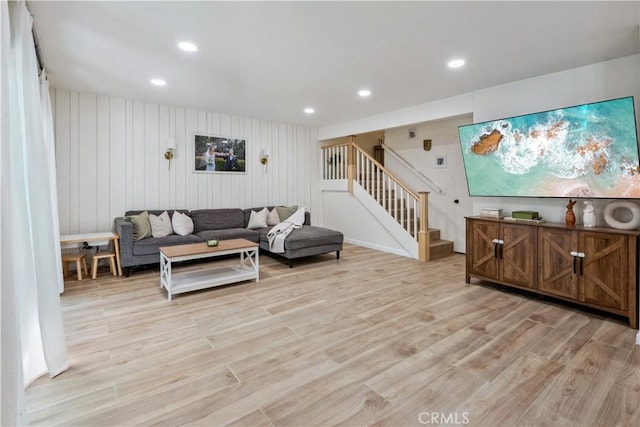 living room with stairs, recessed lighting, and light wood-type flooring